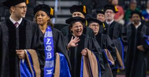 Doctoral students in caps and gowns at commencement.