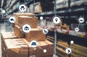 Stack of cardboard boxes are sitting in a warehouse with icons hovering in front of them.