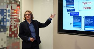 Shot of Suzannah Hicks in front of presentation screen.