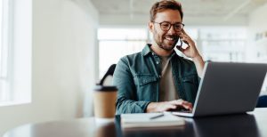 business student on cell phone and laptop
