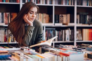 students in library reading a book