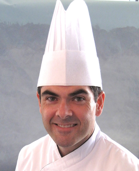 Headshot of Chef Tom DeRosa in chef's hat.