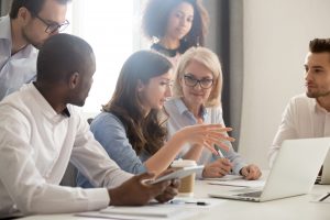 group of professionals in an office talking