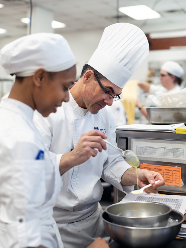 Chef Tom DaRosa and JWU student cooking.