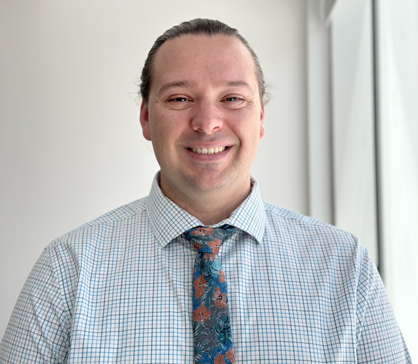 Headshot of JWU Senior Instructional Designer/Technologist, Steve Barnes, wearing a shirt and tie.