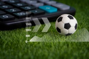 soccer ball on field with image of calculator and graph