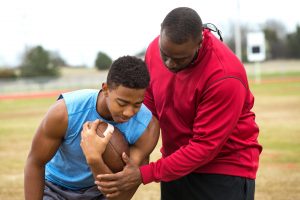 coach with young athlete