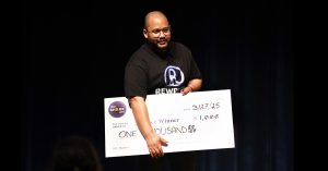 Randy Benitez holding large sign designed to look like a $1,000 check.