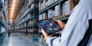 supply chain manager in warehouse looking at tablet