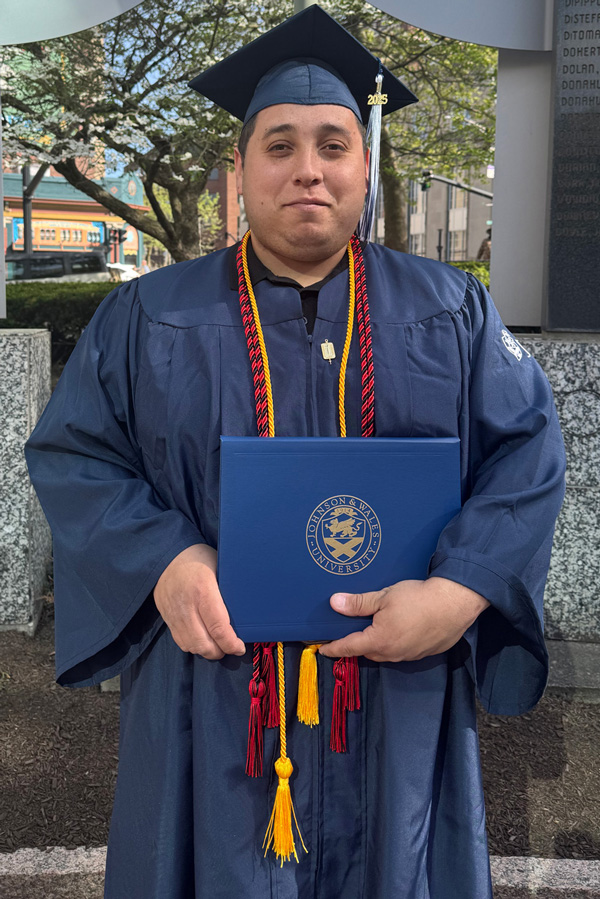 Albert Torres in graduation cap and gown.