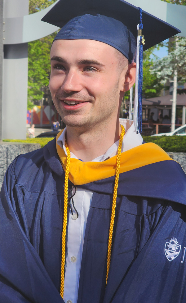 Ben Huntzinger in graduation cap and gown.