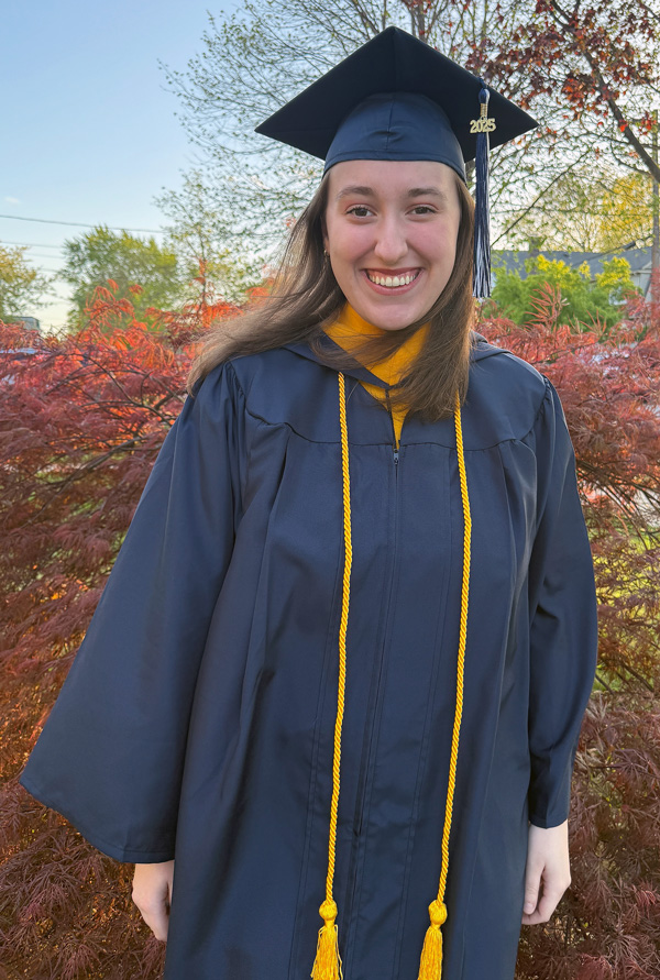 Chloe LaSalle outdoors in her graduation cap and gown.