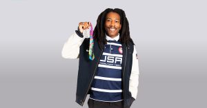 Paralympic athlete Markeith Price, wearing a USA shirt holding a medal he won.