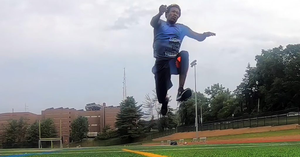 Markeith practicing jumps for a track and field event.