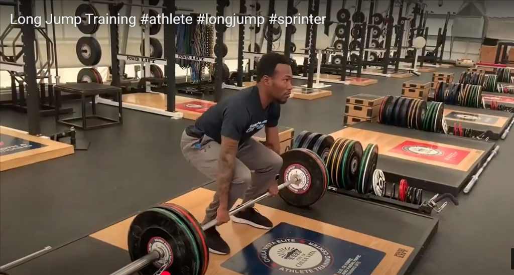 Markeith in the gym lifing weights for his long jump training.