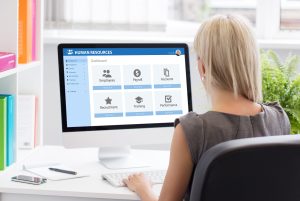 Woman working with human resources software and HR metrics