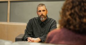 View from back of seated counselor to seated male client.