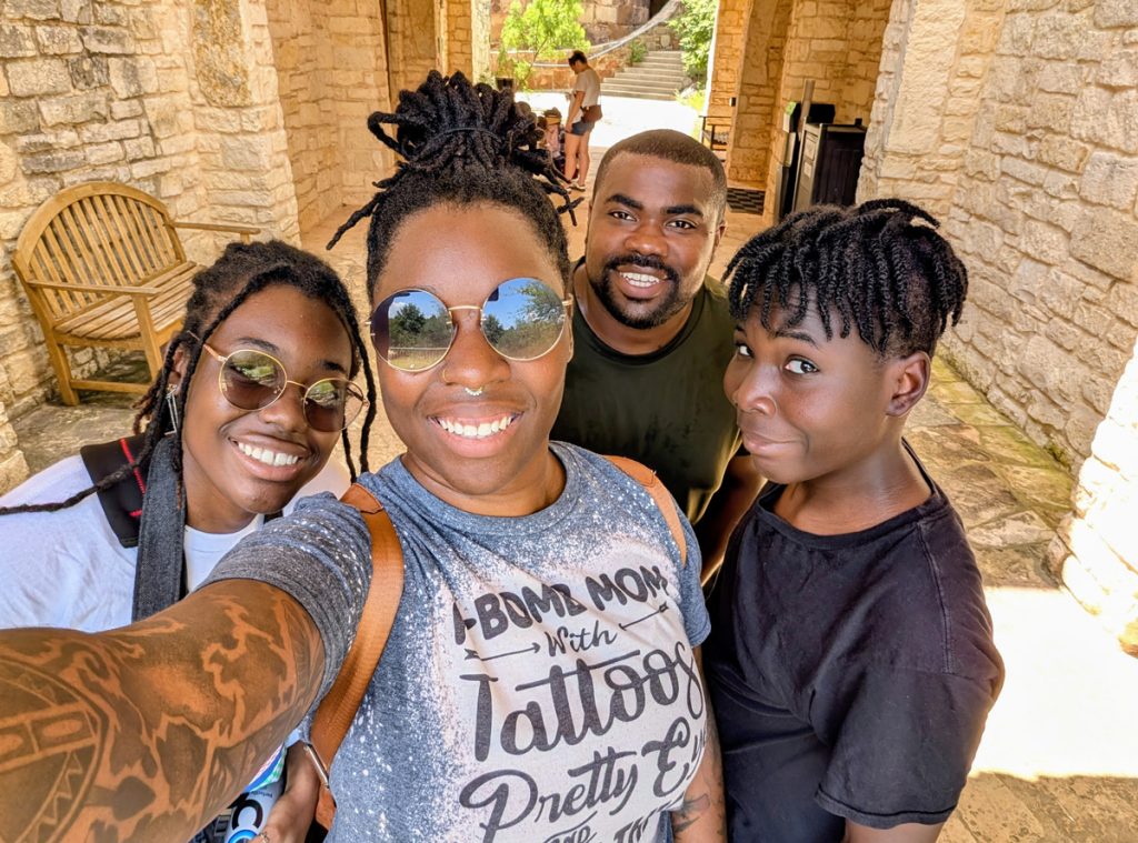 Selfie of Direka Gordon, her son, husband and daughter smiling into the camera.