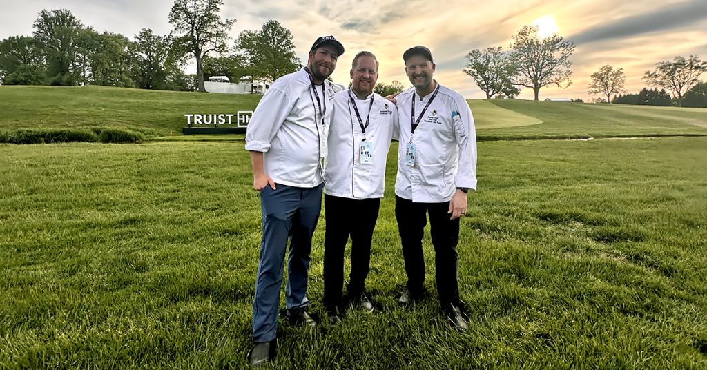 Stephen Taylor standing with the sous chef and executive chef together on the lawn at the 2025 PGA Tour Truist Championship.