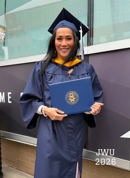 Mercedes Sanchez - Whisenant in her cap and gown holding her diploma after the ceremony at the Amica Mutual Pavilion.