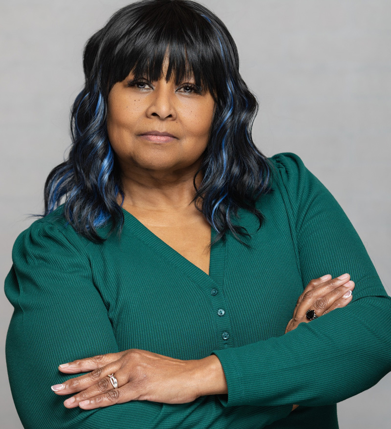 Portrait of Sharon Curry-Lynch wearing a green top.