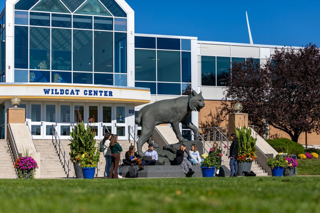Students sitting outside on the steps of the Wildcat Center on at the Harborside Campus of Johnson & Wales University.